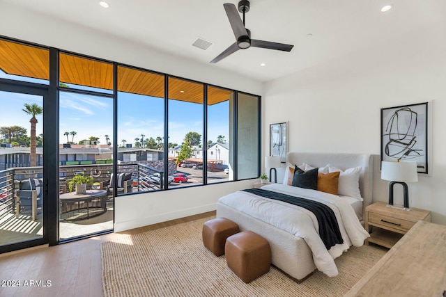 bedroom featuring wood-type flooring, access to outside, and ceiling fan