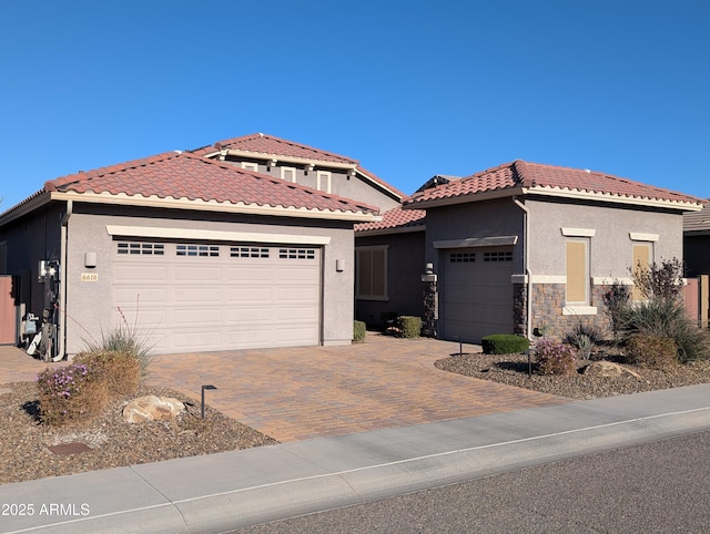 mediterranean / spanish-style home with a garage