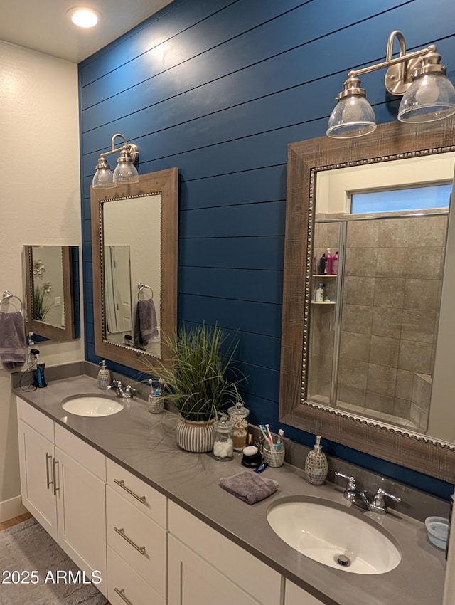 bathroom featuring vanity and wooden walls