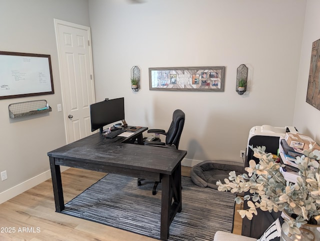 home office with light hardwood / wood-style floors