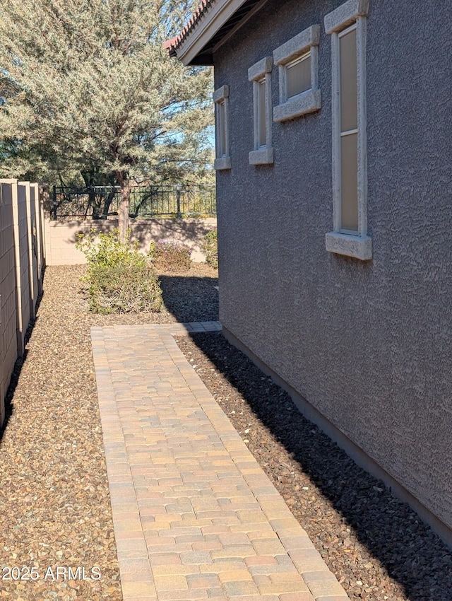 view of property exterior with a patio area