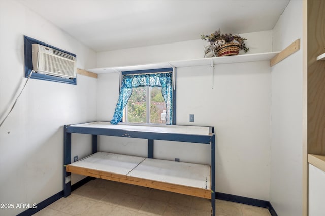 detailed view of baseboards and a wall mounted AC