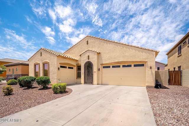 mediterranean / spanish home with a garage