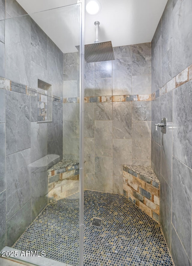 bathroom featuring tiled shower