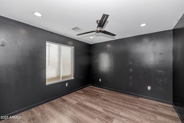 spare room with wood-type flooring and ceiling fan