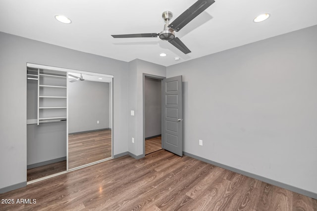 unfurnished bedroom featuring wood-type flooring, ceiling fan, and a closet