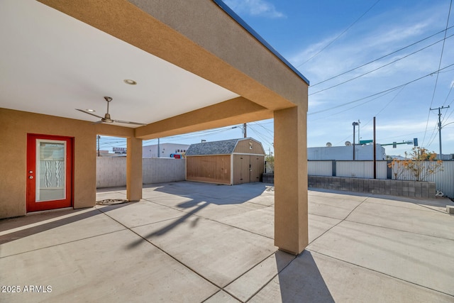 view of patio featuring ceiling fan and a storage unit