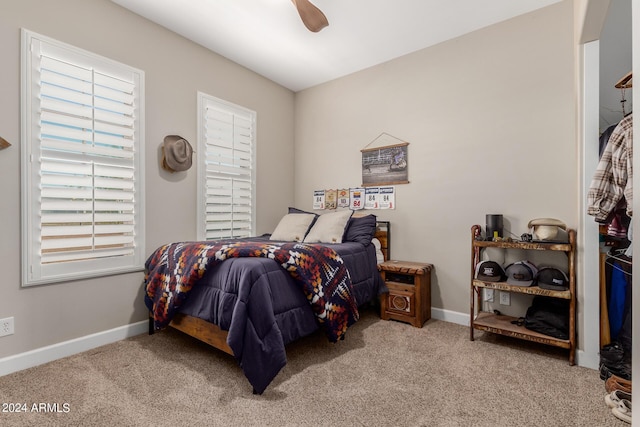 bedroom with ceiling fan and light colored carpet