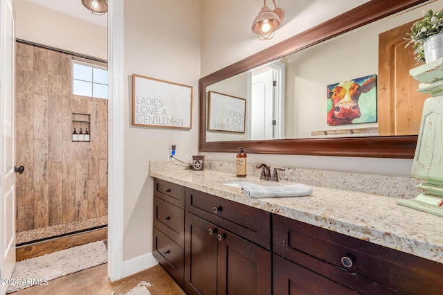 bathroom featuring vanity and a tile shower