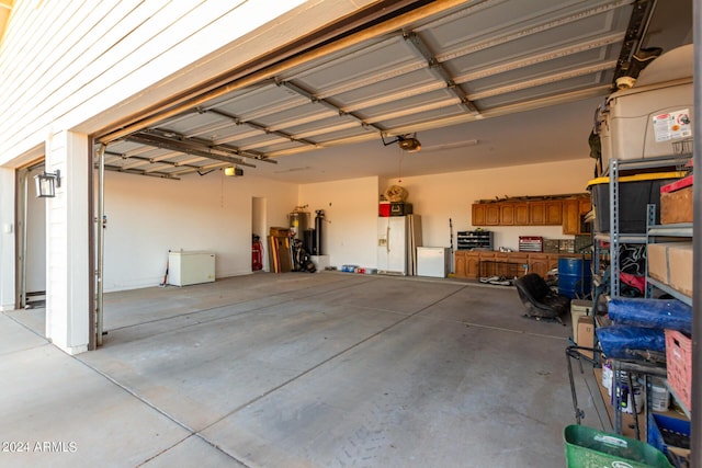 garage featuring a garage door opener, white fridge with ice dispenser, and water heater