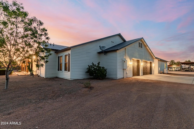 property exterior at dusk featuring a garage