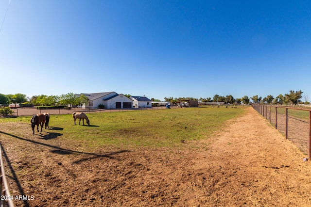 view of yard with a rural view