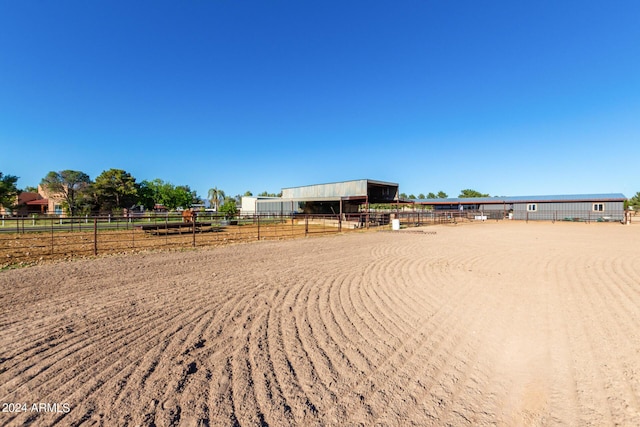 view of yard with a rural view and an outdoor structure