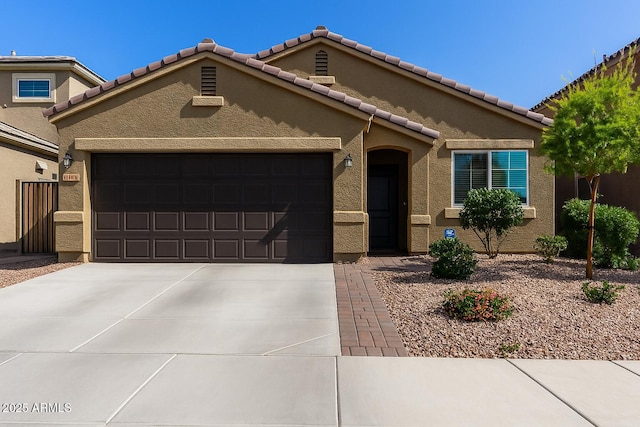 2023 W Yellowbird Ln, Phoenix, AZ 85085 - view of front of property with an attached garage, driveway, stucco siding, and a tile roof