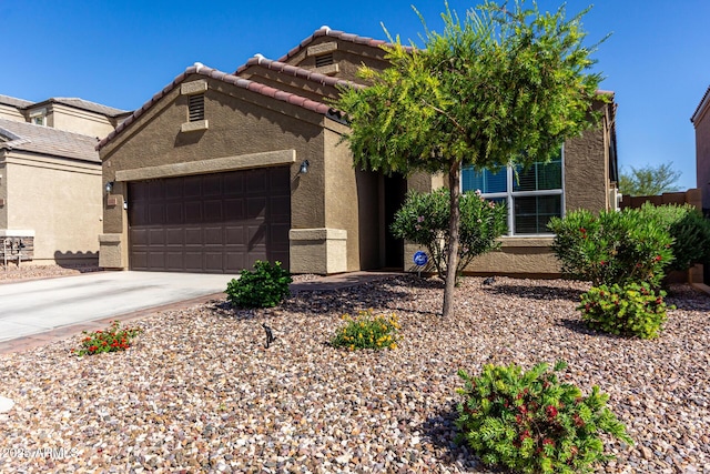 2023 W Yellowbird Ln, Phoenix, AZ 85085 - view of front of house featuring stucco siding, a garage, driveway, and a tiled roof