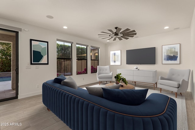 living room featuring light wood finished floors, ceiling fan, baseboards, and recessed lighting