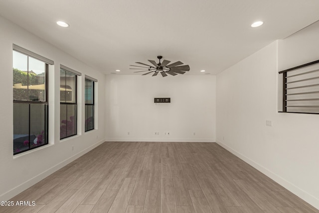 unfurnished room with a ceiling fan, light wood-type flooring, baseboards, and recessed lighting