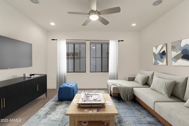 living area featuring ceiling fan, baseboards, wood finished floors, and recessed lighting