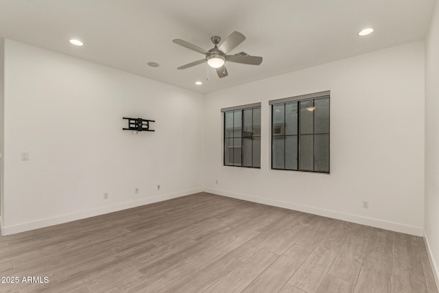 spare room with a ceiling fan, baseboards, wood finished floors, and recessed lighting