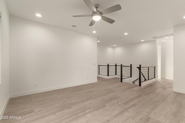 unfurnished room with light wood-style floors, recessed lighting, visible vents, and baseboards