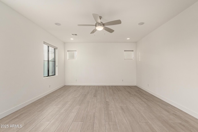 spare room featuring a ceiling fan, recessed lighting, light wood-style flooring, and baseboards