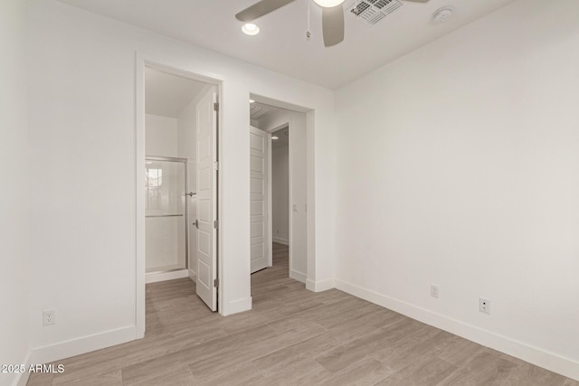 unfurnished bedroom with visible vents, ensuite bathroom, a ceiling fan, light wood-type flooring, and baseboards