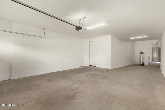 garage with water heater and a garage door opener