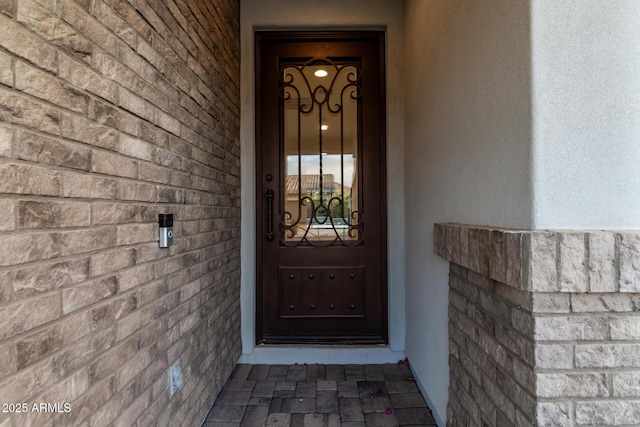 view of exterior entry featuring stucco siding