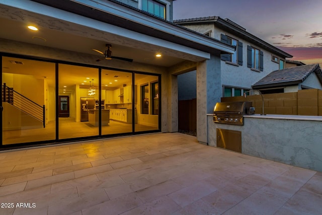 view of patio with a grill, an outdoor kitchen, and fence