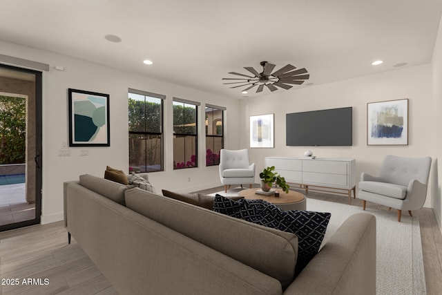 living room featuring a ceiling fan, recessed lighting, light wood-style flooring, and baseboards