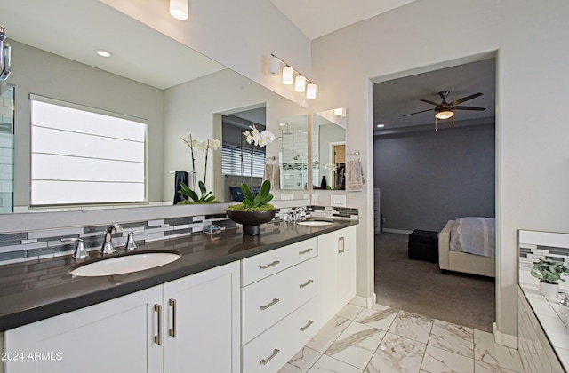 bathroom with vanity, a shower, and ceiling fan with notable chandelier