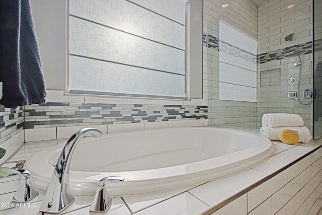 bathroom featuring separate shower and tub