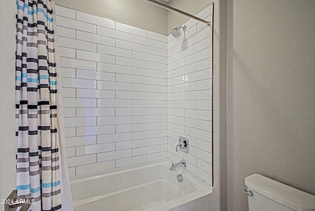 bathroom with toilet and shower / bath combination with curtain