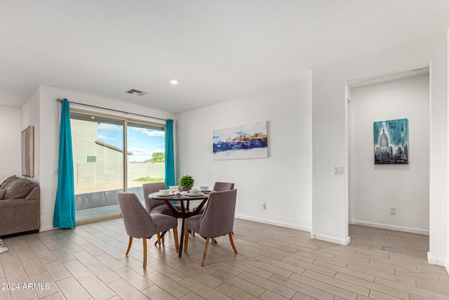 dining space with light hardwood / wood-style floors