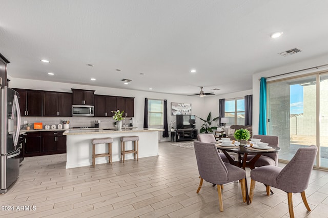 dining room featuring light hardwood / wood-style floors and ceiling fan