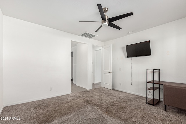 interior space with ceiling fan and carpet flooring