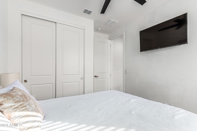 bedroom with ceiling fan and a closet