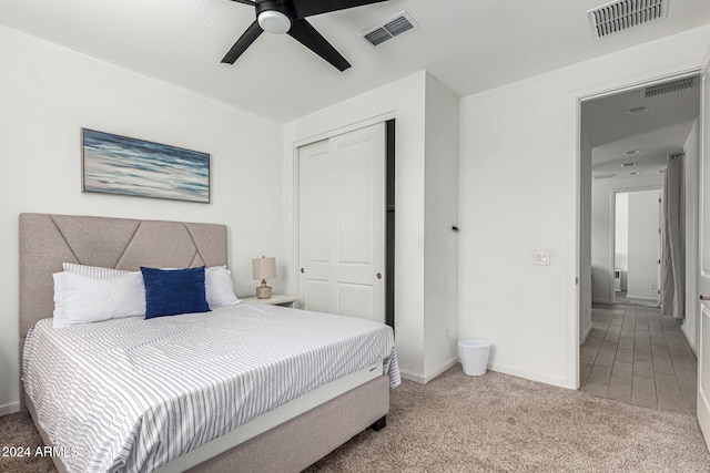 carpeted bedroom featuring a closet and ceiling fan