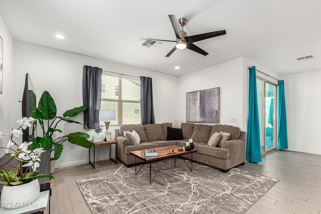 living room featuring hardwood / wood-style flooring and ceiling fan