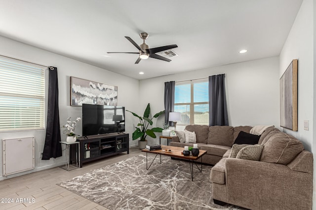 living room with hardwood / wood-style flooring and ceiling fan