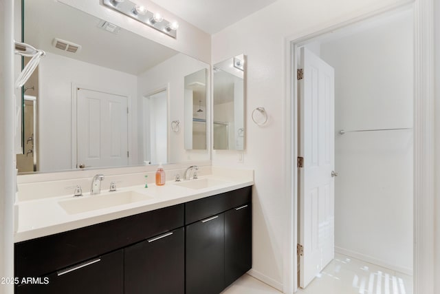 1502 E Goldcrest St, Gilbert, AZ 85297 - bathroom featuring double vanity, baseboards, and tile patterned floors