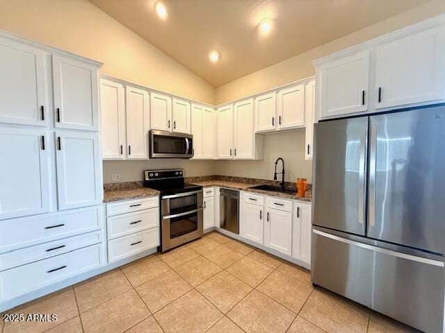 kitchen with white cabinetry, appliances with stainless steel finishes, sink, and light tile patterned flooring