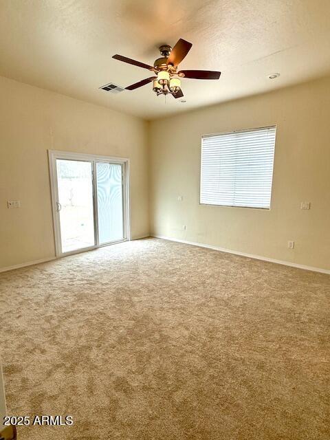 carpeted spare room with ceiling fan and a textured ceiling