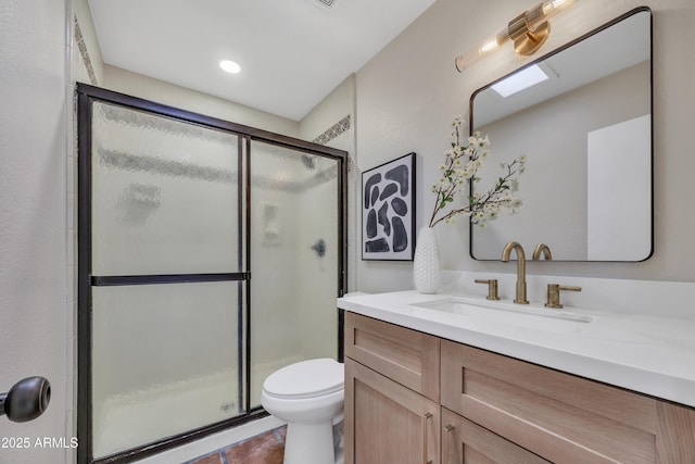 full bathroom featuring vanity, tile patterned floors, toilet, and a shower stall