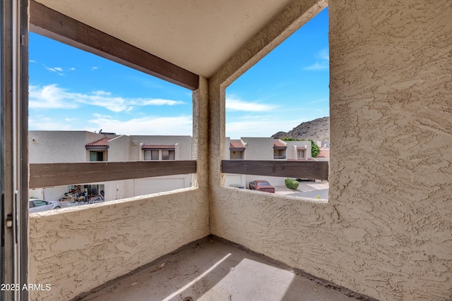 balcony featuring a residential view and a mountain view