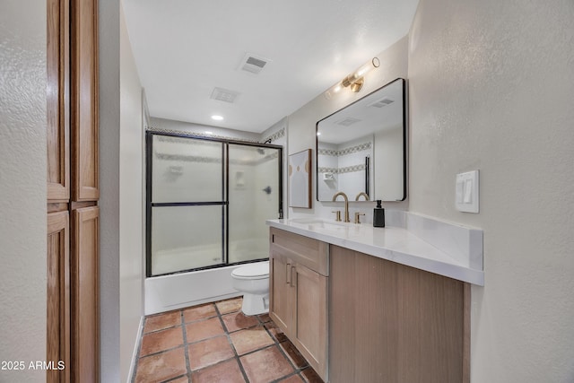 bathroom with visible vents, a textured wall, toilet, and vanity
