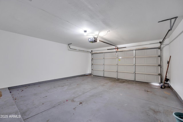 garage with baseboards and a garage door opener