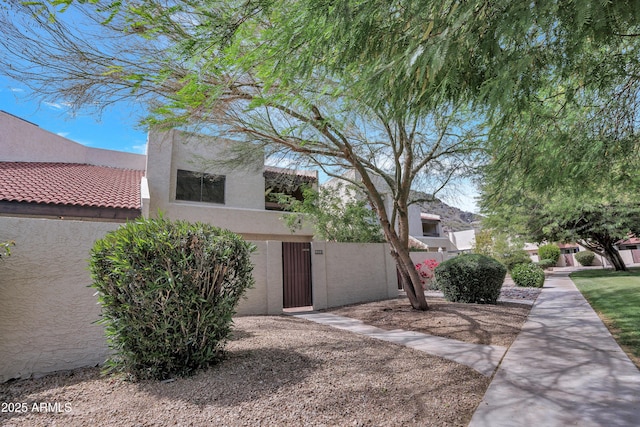 view of front of house featuring a gate, a fenced front yard, and stucco siding