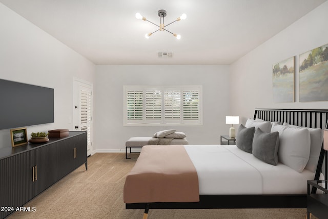 bedroom featuring a chandelier and light carpet