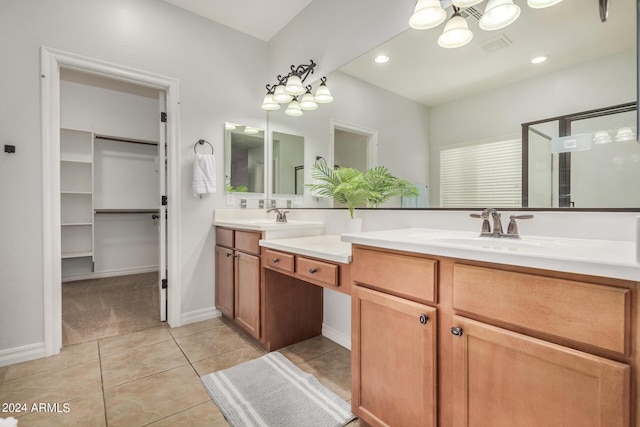 bathroom featuring vanity, tile patterned floors, and an inviting chandelier